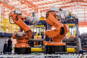 Featured image showing two industrial welding robots in a production line at a modern manufacturing factory