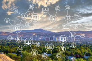 Featured image showing the city of Reno, Nevada with a blockchain illustration laid over it.