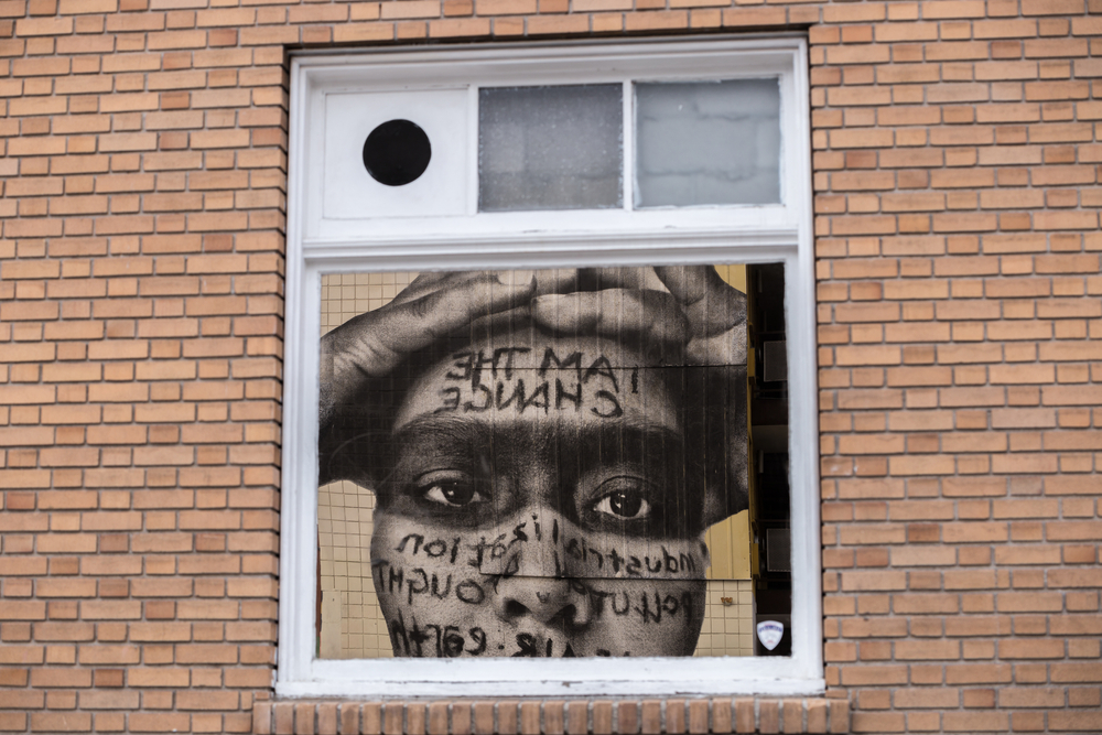 Featured image showing a mural in downtown reno of a person shut down by the Pandemic