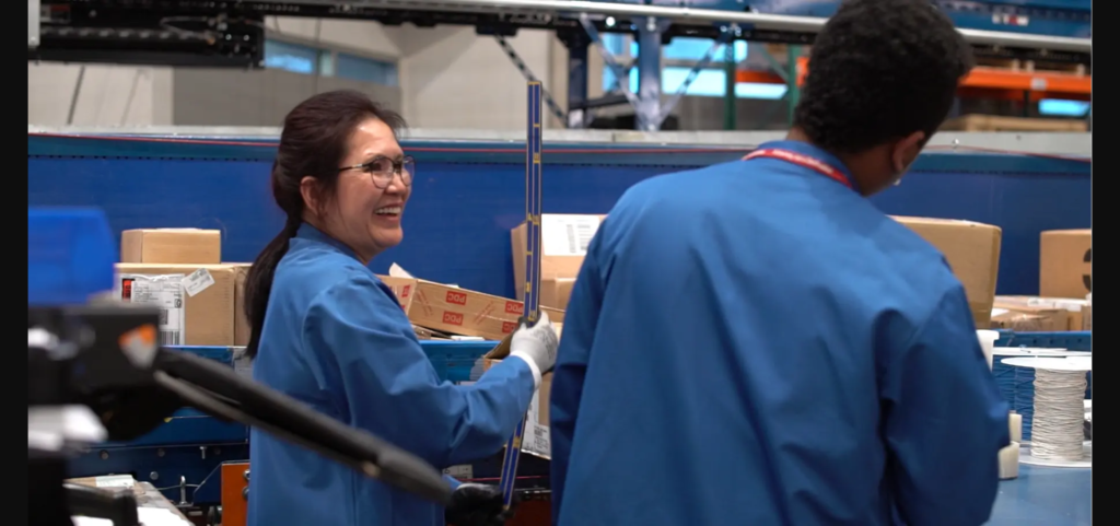 Featured image showing two Arrow Electronics warehouse workers laughing and smiling.