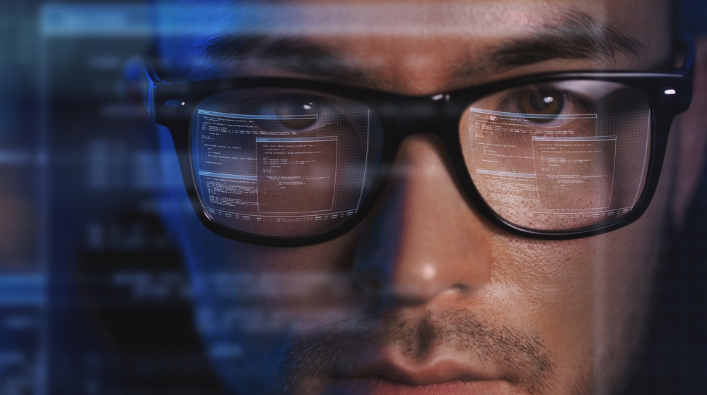 featured image showing a man concentrating on code