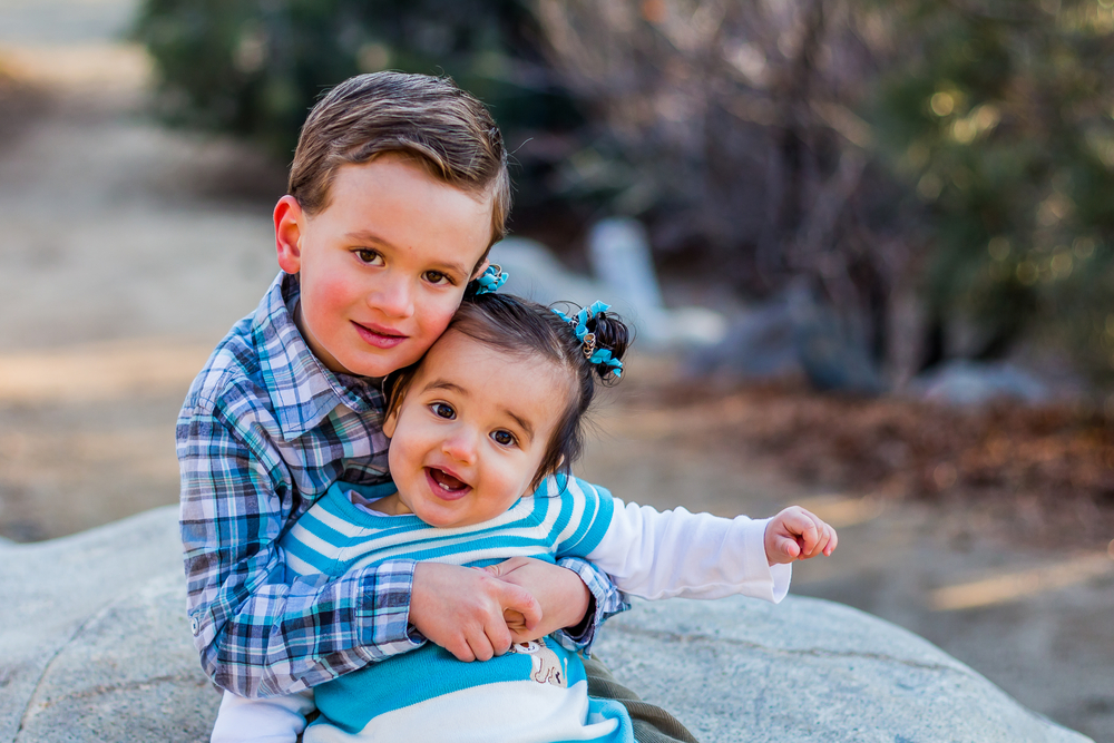 Featured image showing a cute little brother and sister dressed in blue, posing for a picture at San Rafael Park in Reno, NV