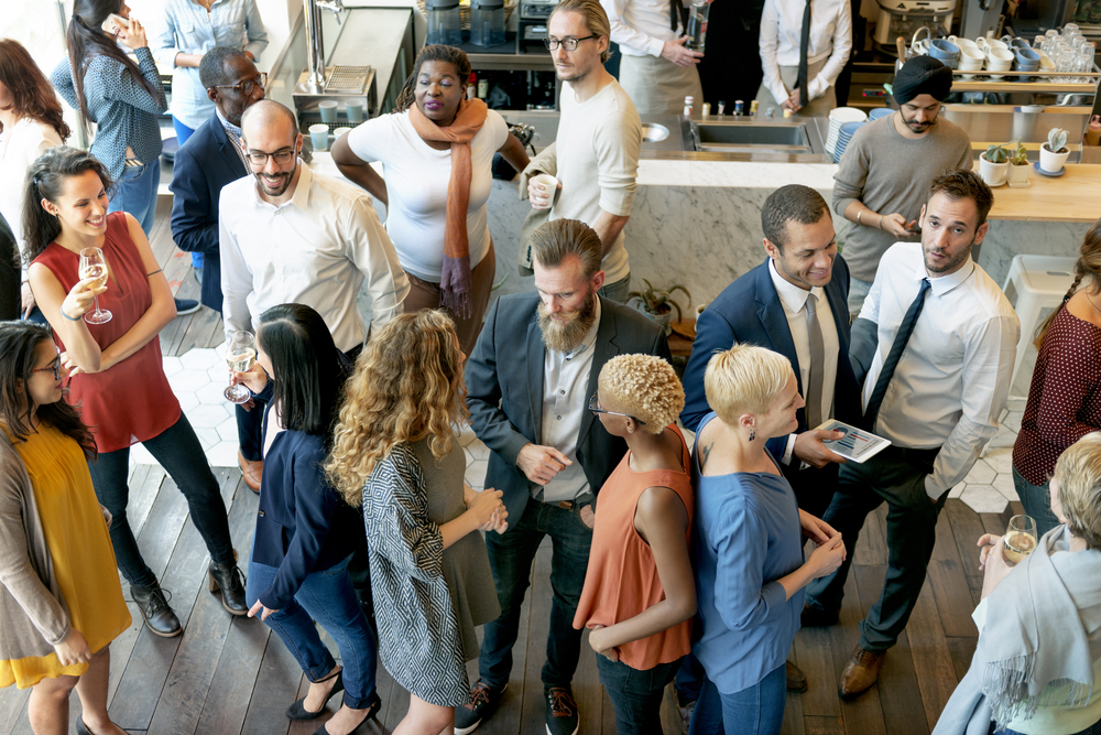 featured image showing a diverse professional crowd networking at a holiday party.