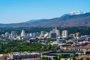 Featured image showing the Reno, Nevada Skyline with mountains in the background on a clear day.