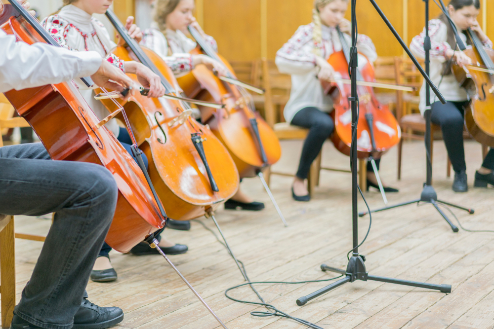 Inline image showing a group of young people practicing the cello on a stage