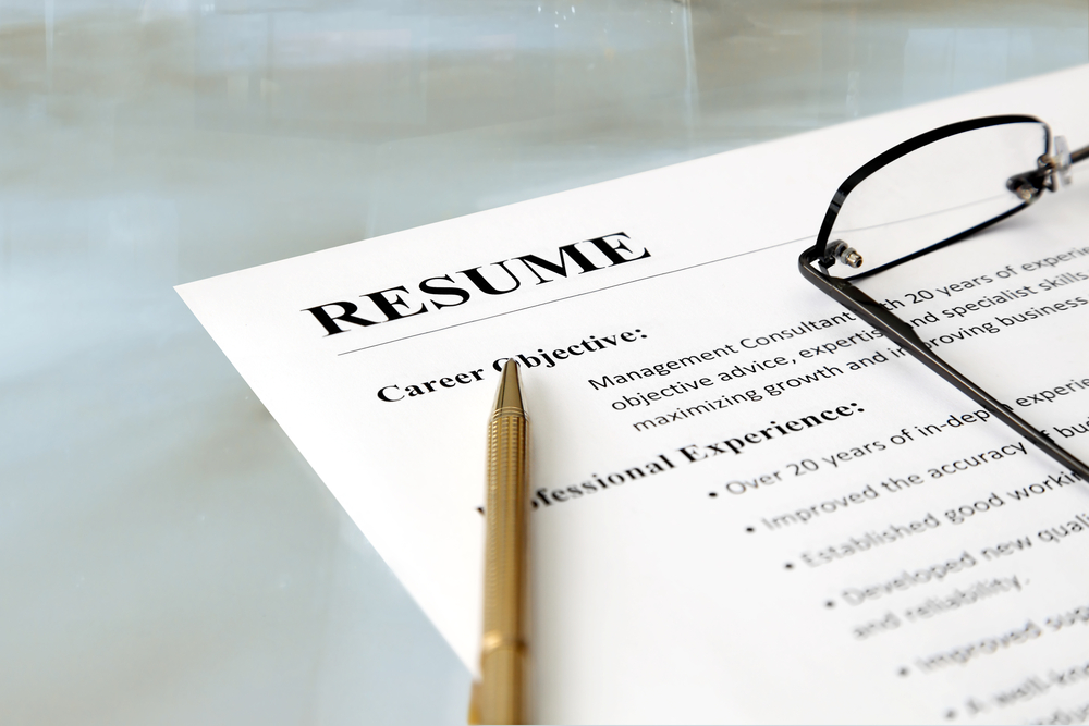 FEatured image showing Closeup of resume with pen and glasses on the table
